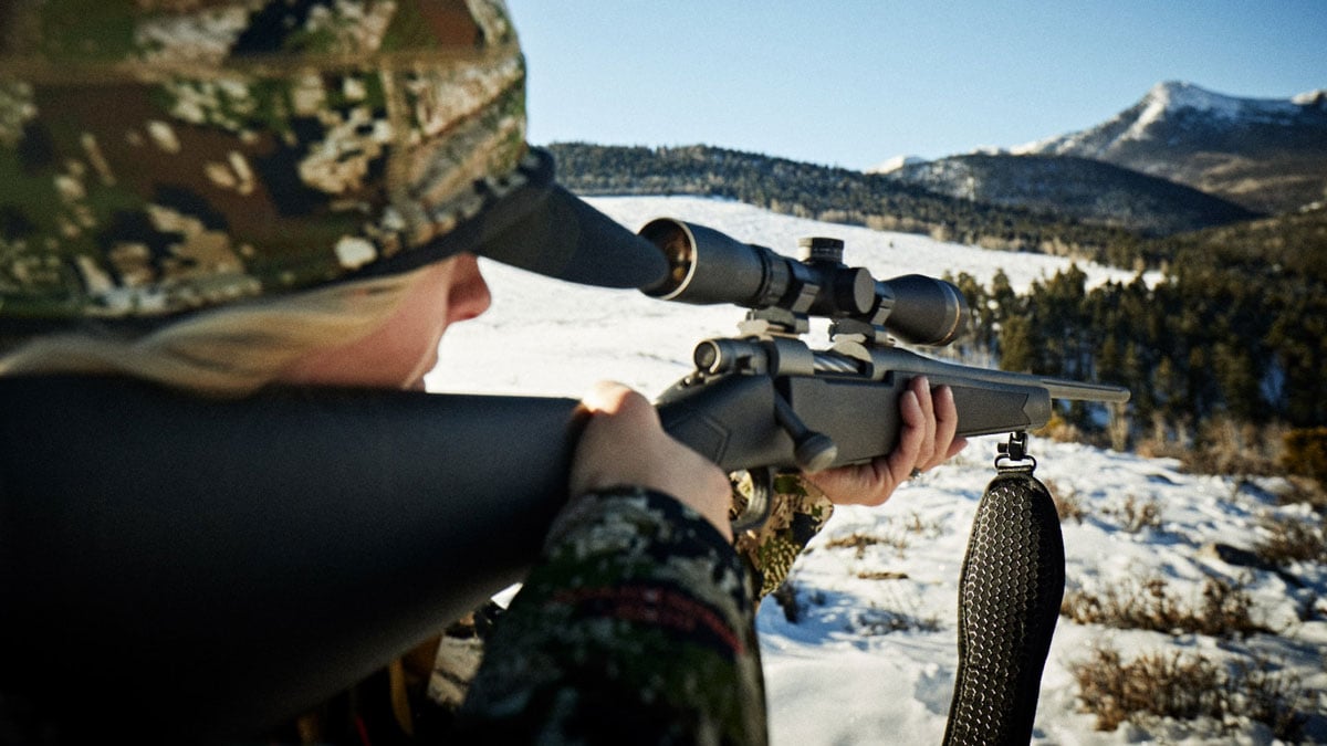 Hunter holding Mossberg Patriot rifle while shooting