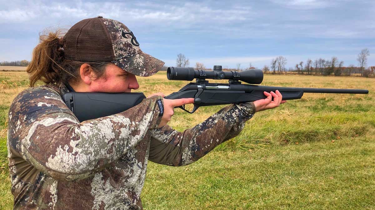 Hunter holding Benelli Lupo rifle in field
