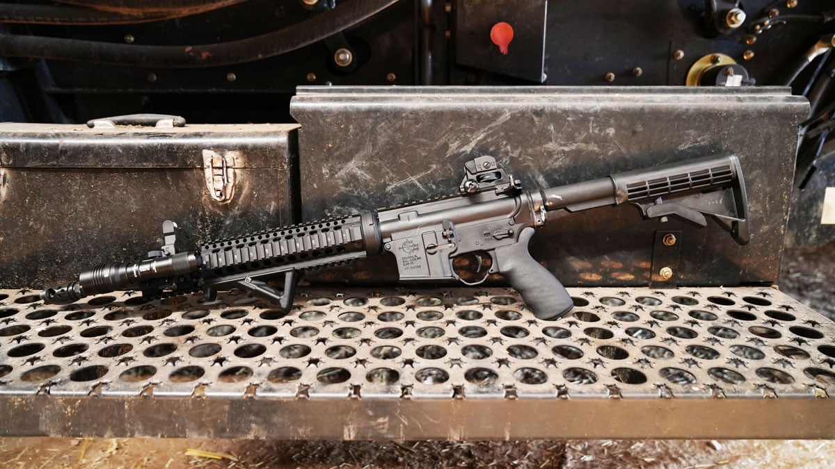 LAR-15 rifle on a metal tractor step