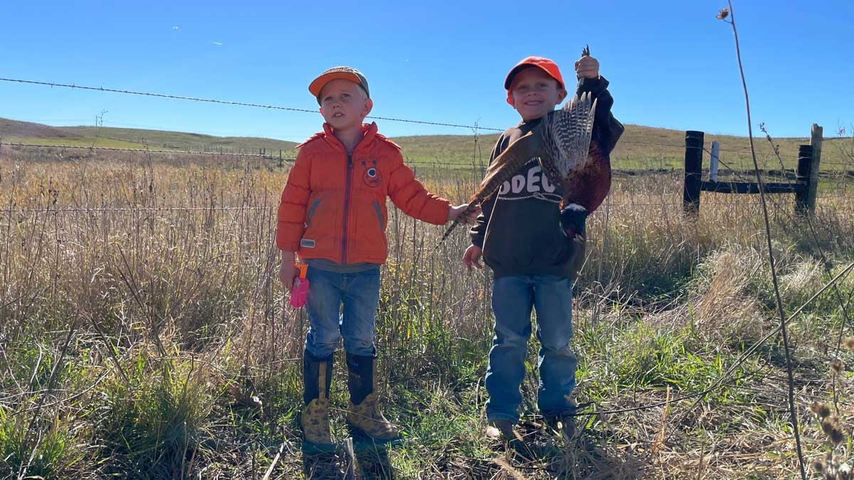 Children with a pheasant after a hunt
