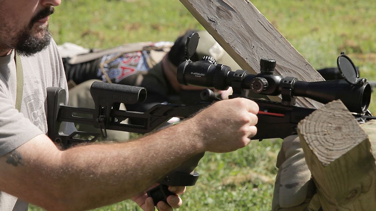 A shooter inserts a chamber flag on the range