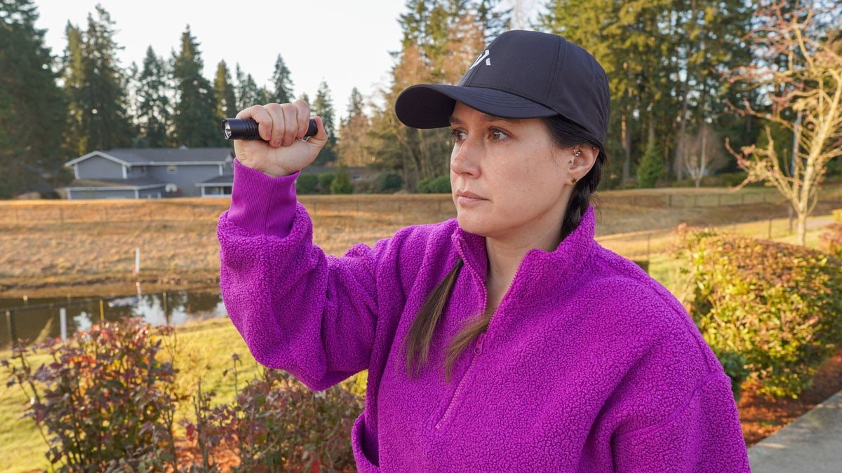 Woman holding tactical flashlight