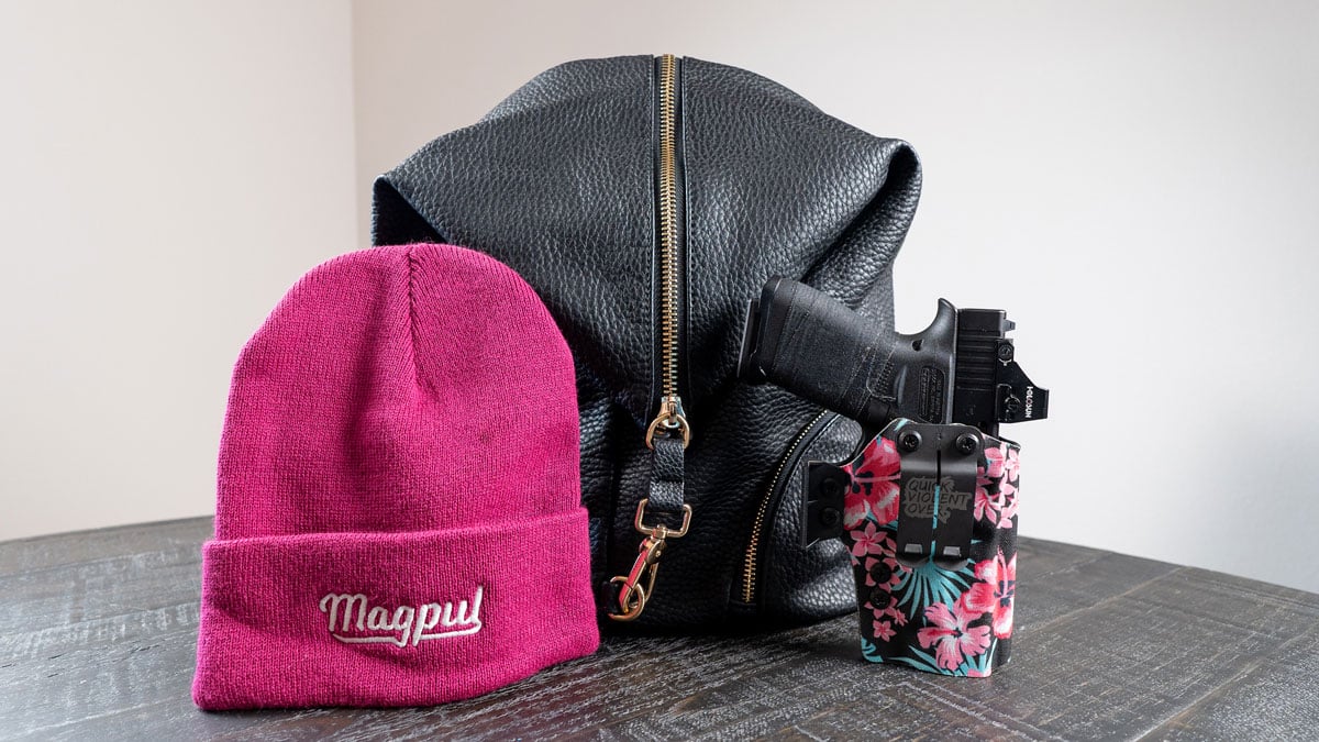 concealed carry handgun in holster with bag and beanie