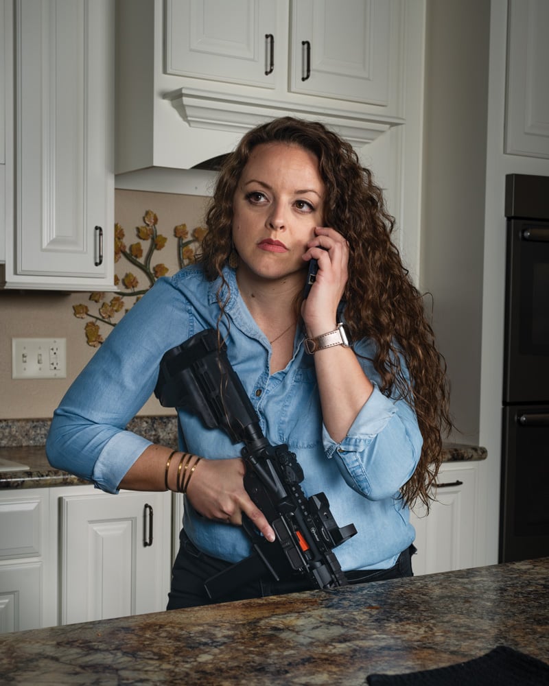 woman in kitchen on phone holding AR