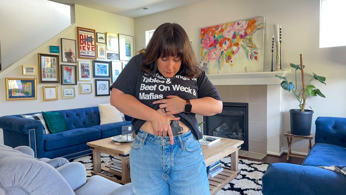 woman drawing handgun from IWB holster