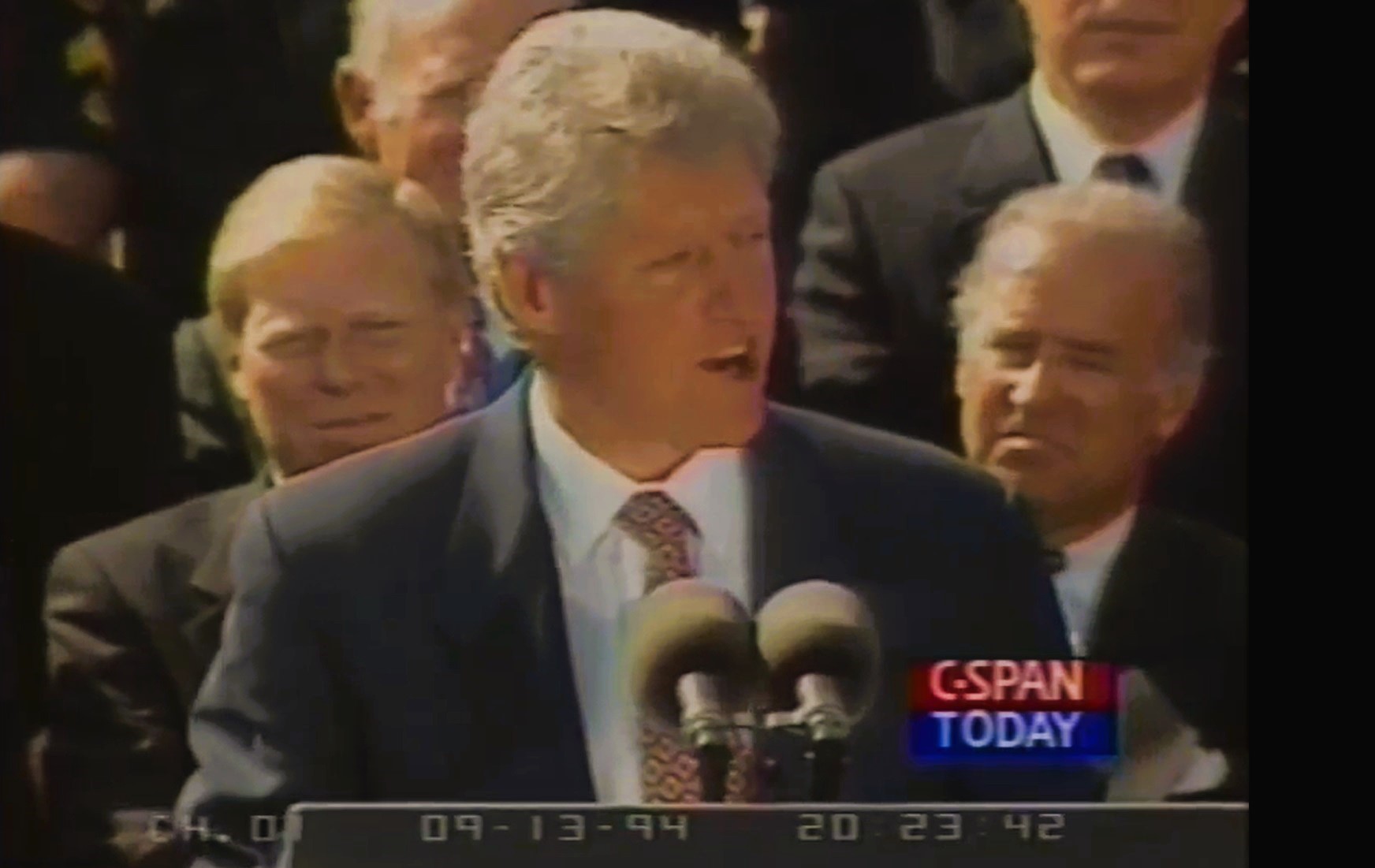 Biden seen behind Clinton at the 1994 signing of the federal assault weapon ban