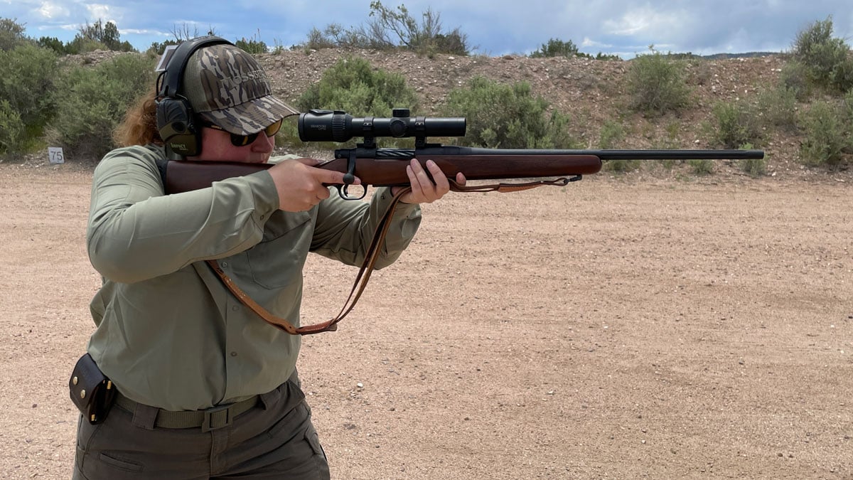 woman aiming rifle in offhand position