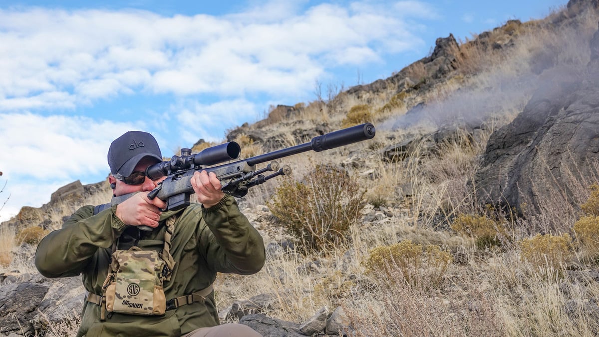 hunter shooting suppressed rifle