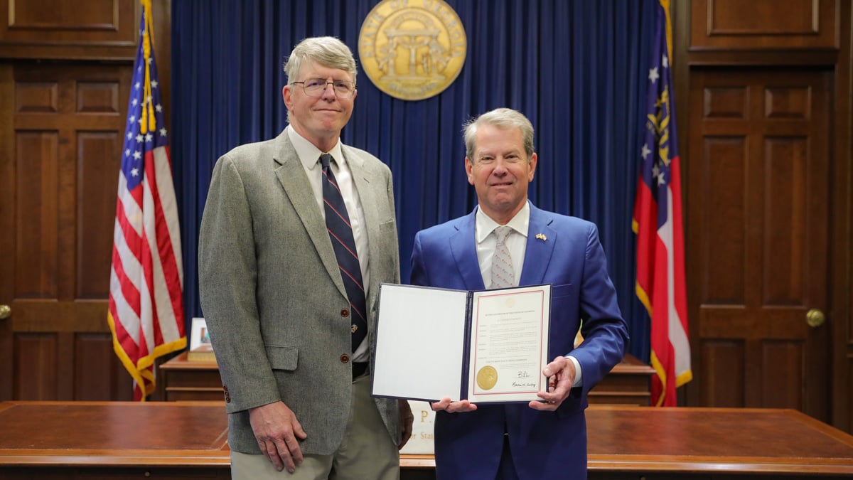 Gov. Brian Kemp gives Joshua Dorsey a commendation at the capital