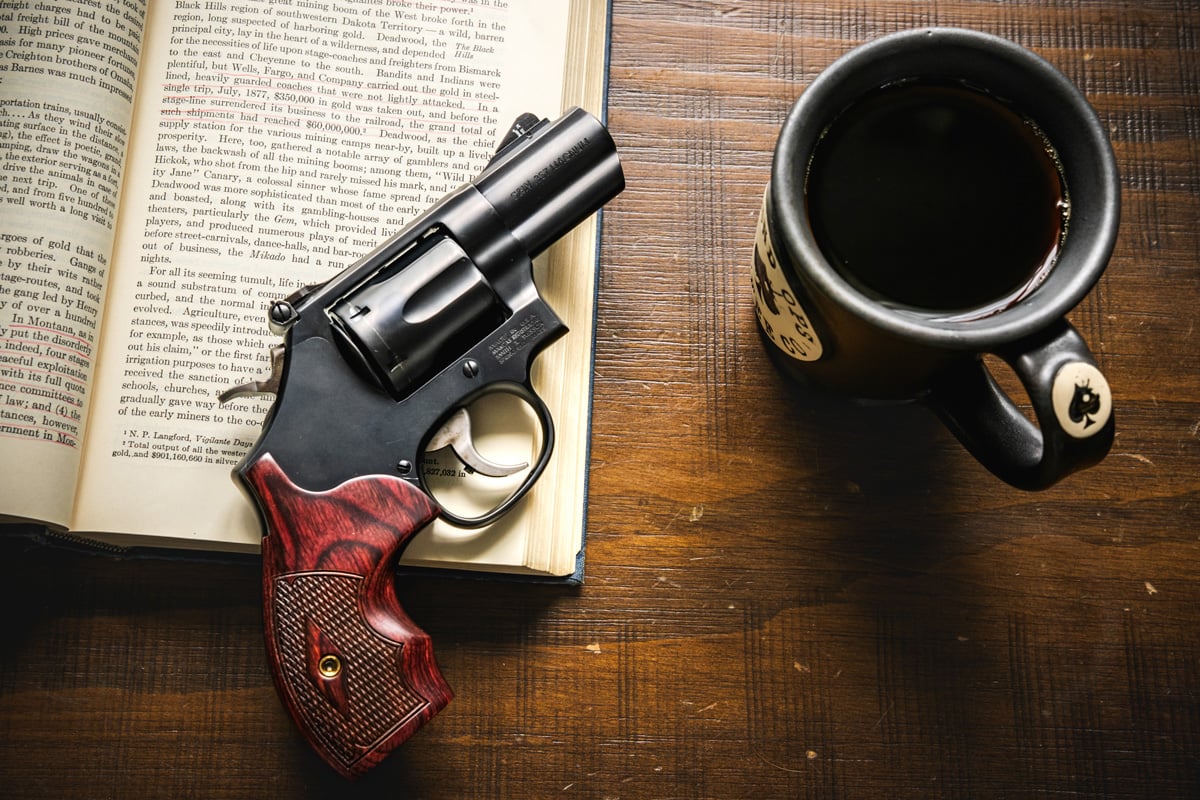 Smith & Wesson Performance Center Model 19 Carry Comp with book and coffee mug