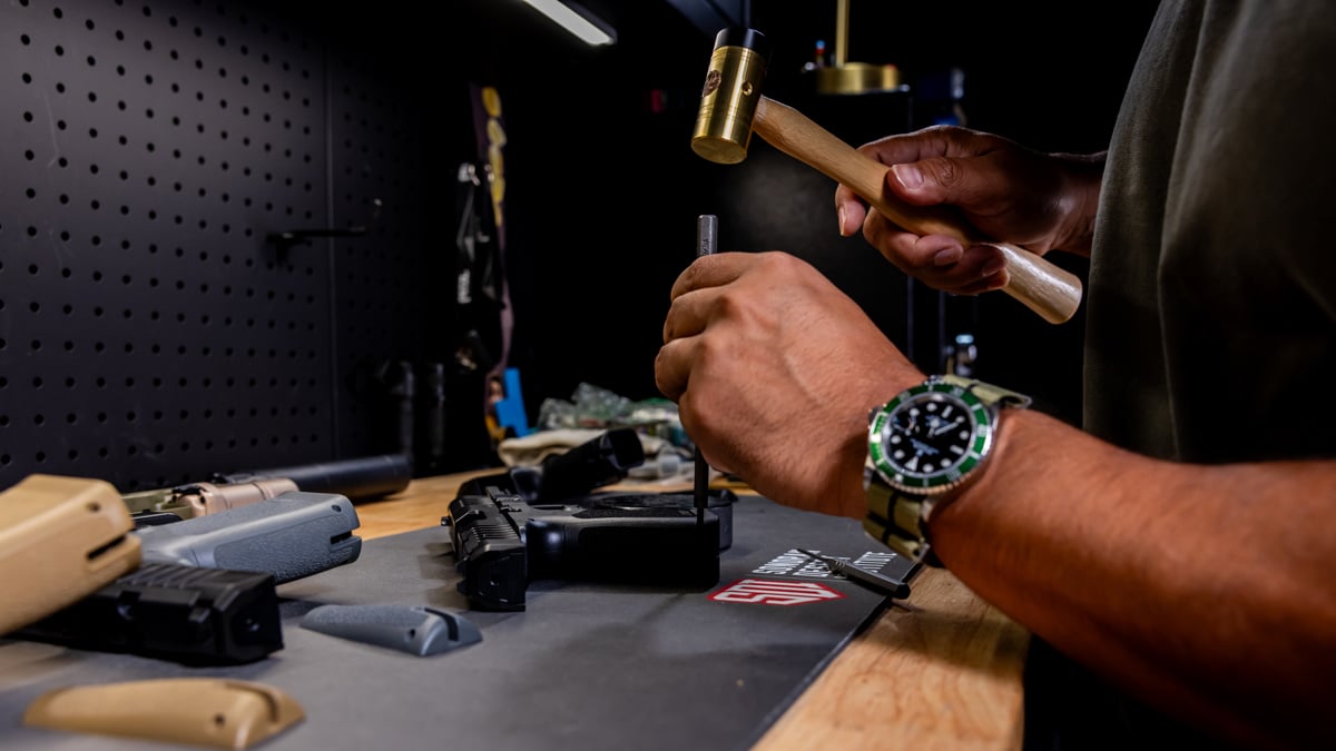gunsmith working on handgun
