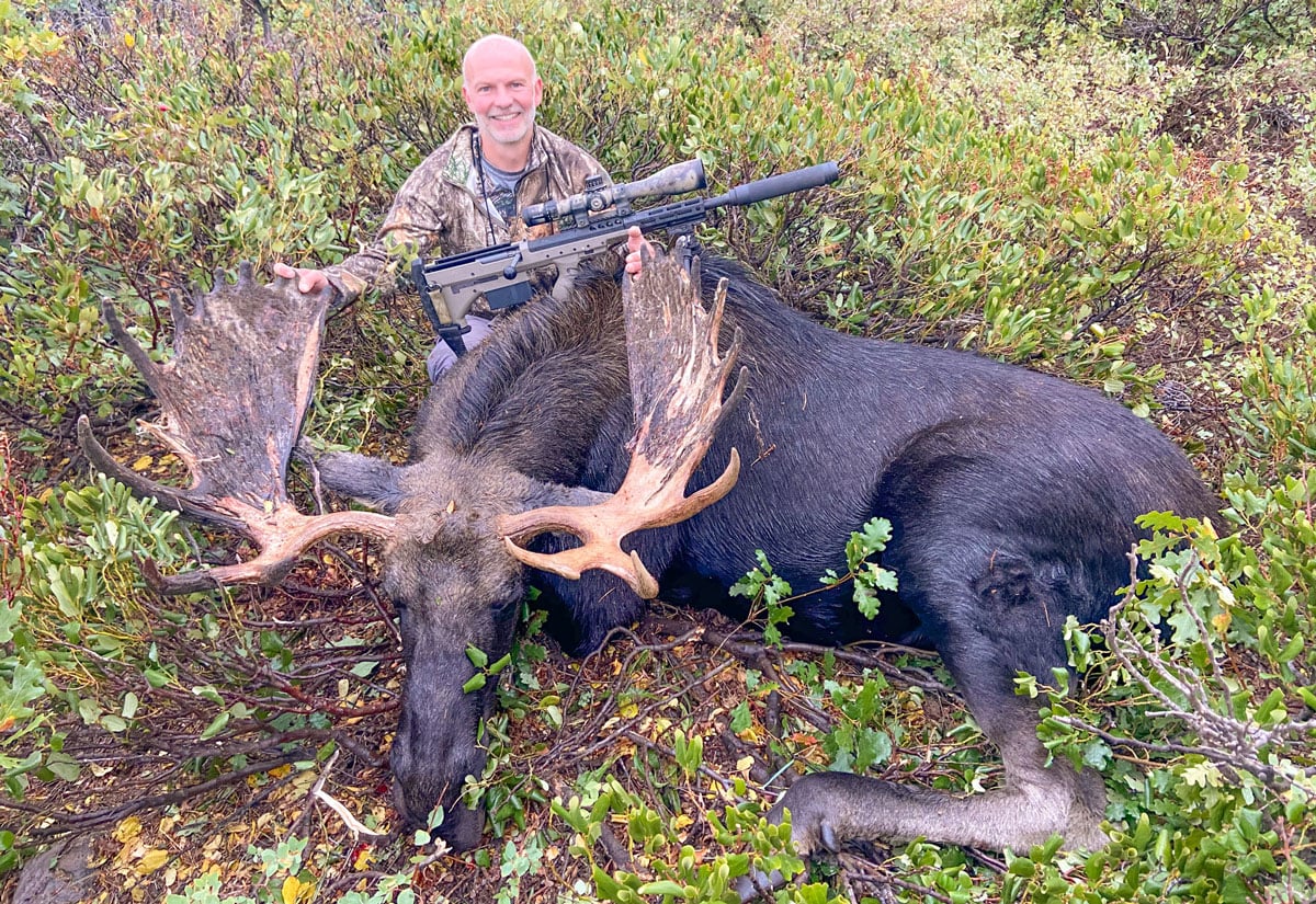 hunter with bull moose
