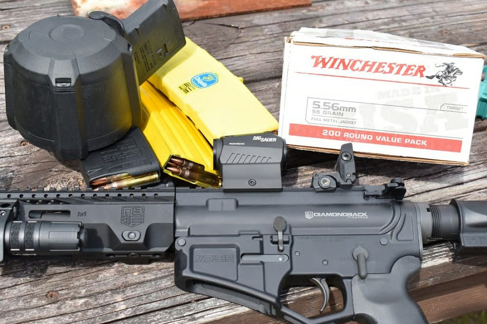 db15 ar pistol with magazine and ammo case on table
