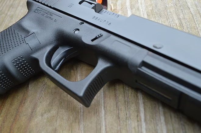 Textured pad on front of the trigger guard of a g40