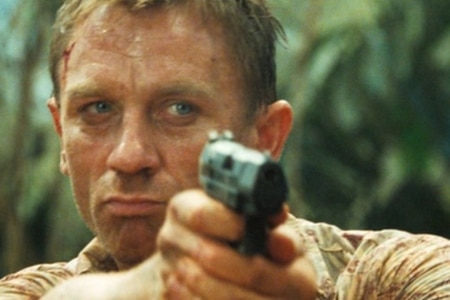 daniel craig as james bond shooting a walther handgun