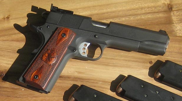 springfield armory range officer handgun on wooden table