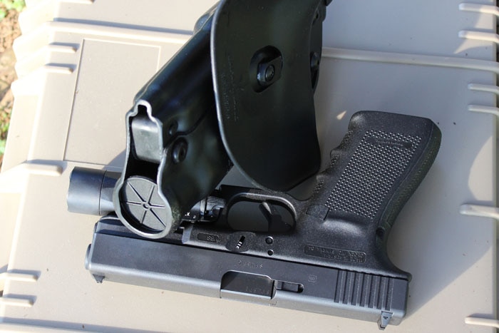 als holster sitting next to gun on case