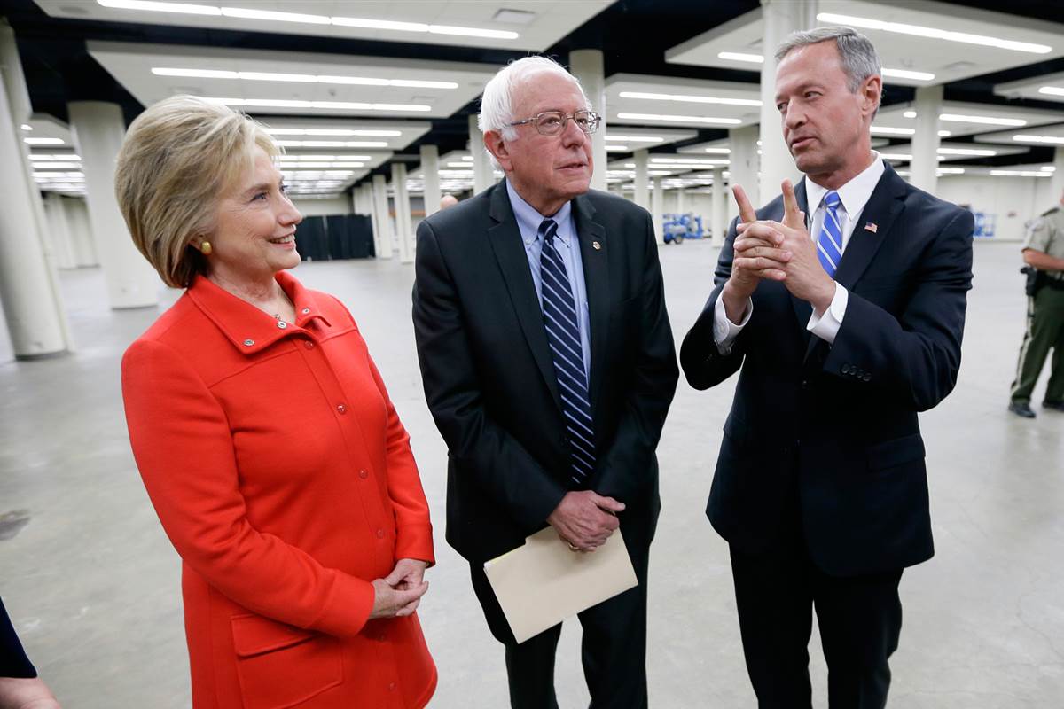 Hillary Clinton, Bernie Sanders and Martin O&rsquo;Malley, talk backstage before the start of the Jefferson-Jackson Dinner. (Charlie Neibergall, AP)
