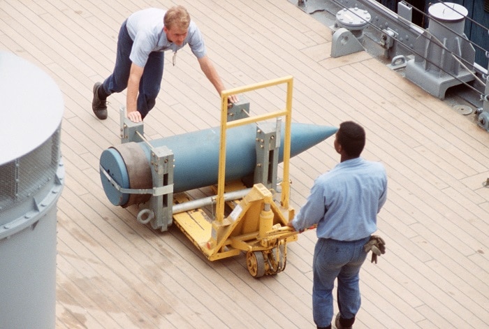 Crewmen load a 16-inch shell aboard the battleship USS WISCONSIN (BB 64) as the vessel is readied for sea trials (Photo: National Archives) 