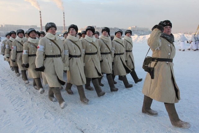 Female medics in heavy coats with Nagant M1895 revolvers in traditional pebble holsters