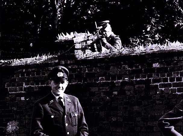 A West German border guard standing just over the line from an East German border guard, the latter armed with a PPsh-41 and a desire to enforce the rules of the People's Republic. (Photo: Library of Congress)